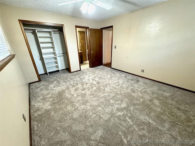 unfurnished bedroom with ceiling fan, light colored carpet, a closet, and a textured ceiling