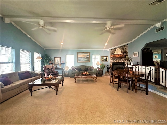 living room with crown molding, a stone fireplace, vaulted ceiling with beams, and ceiling fan