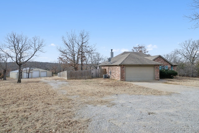 view of home's exterior with a garage and central air condition unit