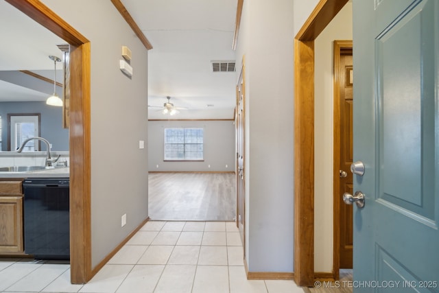 corridor with sink and light tile patterned floors