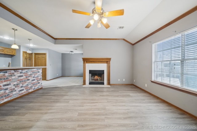 unfurnished living room featuring crown molding, ceiling fan, lofted ceiling, and light hardwood / wood-style floors