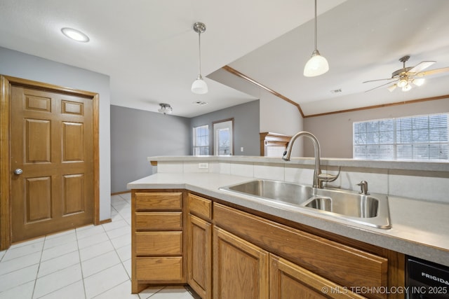 kitchen featuring sink, decorative light fixtures, vaulted ceiling, light tile patterned floors, and ceiling fan