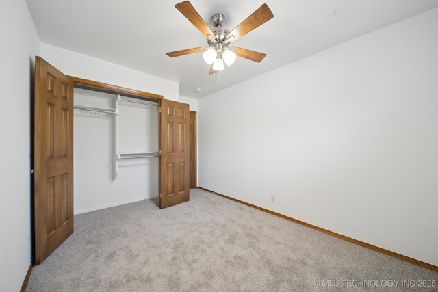 unfurnished bedroom with light colored carpet, a closet, and ceiling fan