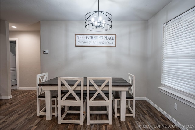 unfurnished dining area with dark hardwood / wood-style flooring and an inviting chandelier