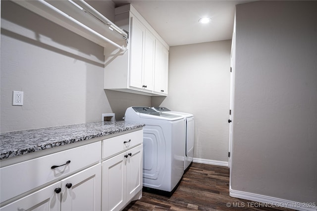 washroom with cabinets, dark hardwood / wood-style flooring, and washer and dryer