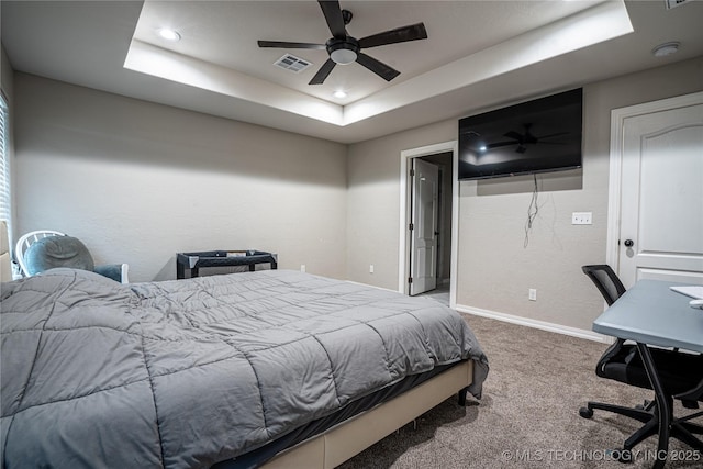 bedroom with a tray ceiling, carpet floors, and ceiling fan