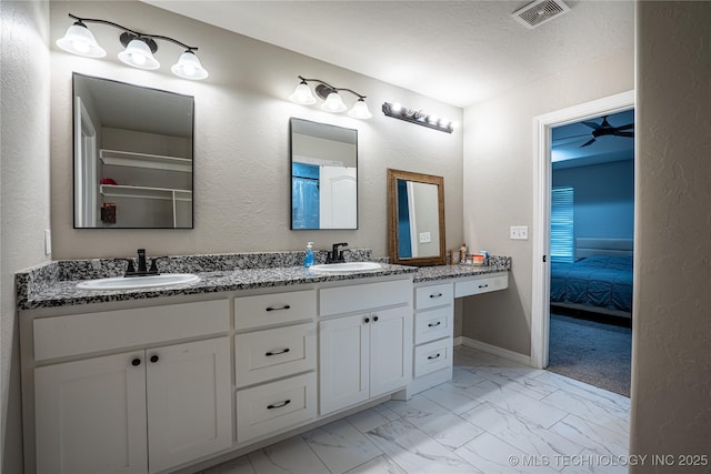 bathroom with ceiling fan and vanity