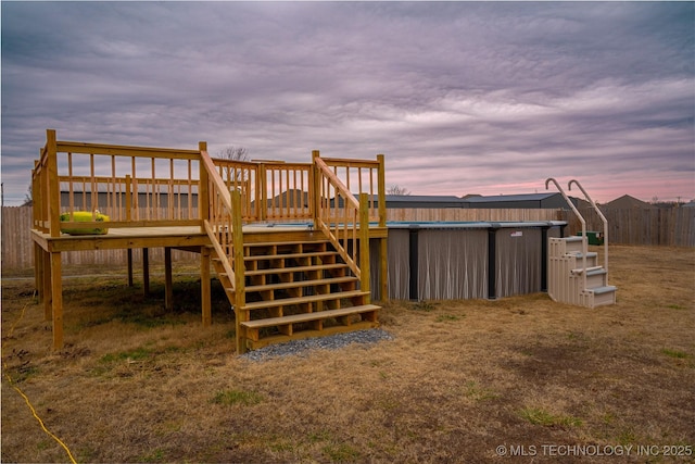 back house at dusk with a deck