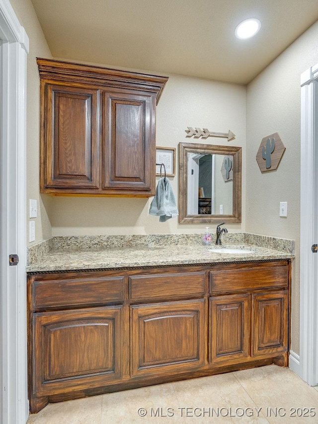 bathroom featuring tile patterned flooring and vanity