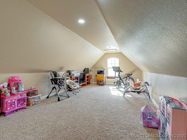 game room featuring carpet floors, a textured ceiling, and vaulted ceiling