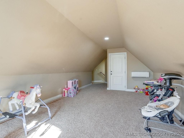 recreation room featuring vaulted ceiling, an AC wall unit, and carpet flooring