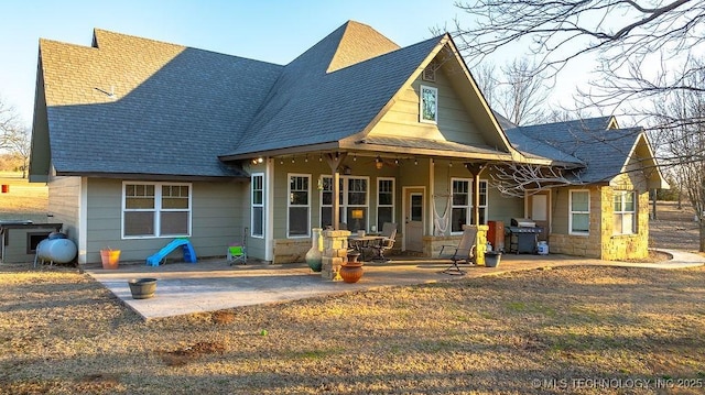 back of property with a patio area and ceiling fan