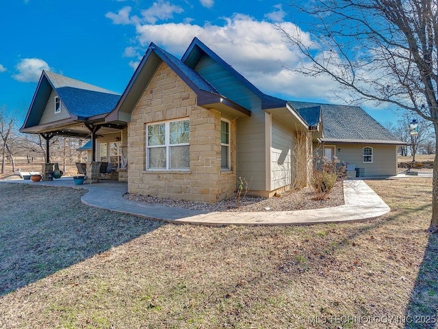 back of property with a garage and a lawn