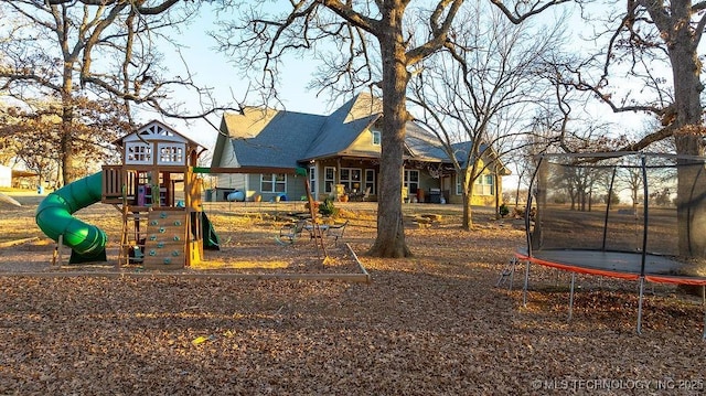 view of jungle gym with a trampoline