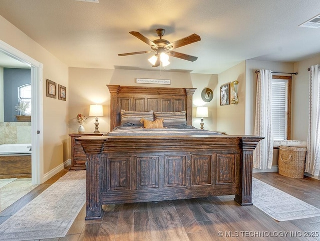 bedroom featuring hardwood / wood-style flooring, ceiling fan, and ensuite bathroom