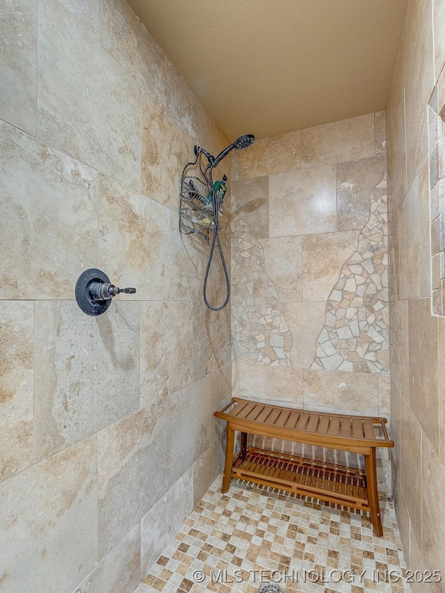 bathroom with a tile shower