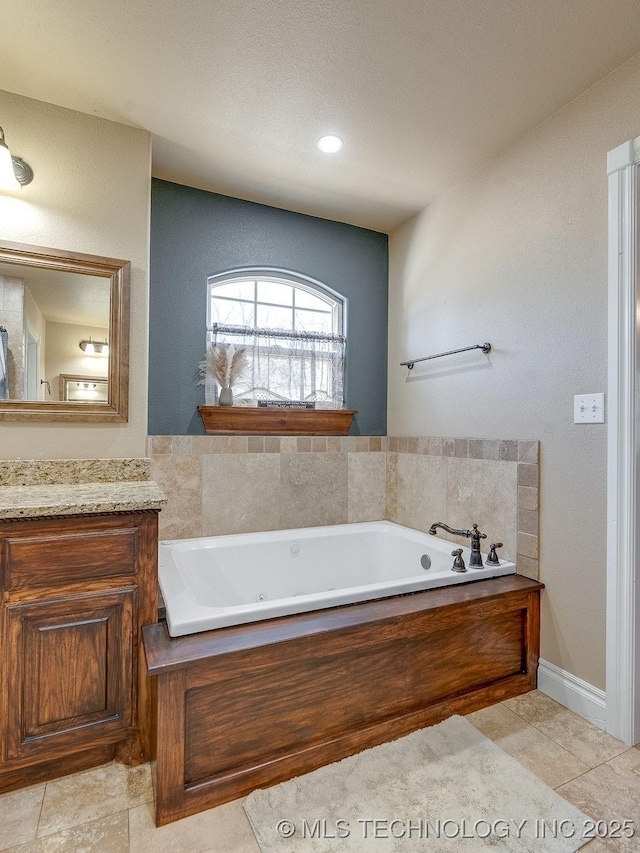 bathroom with vanity, a washtub, and tile patterned floors