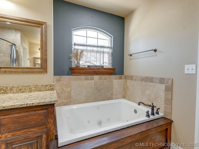 bathroom featuring vanity and a tub