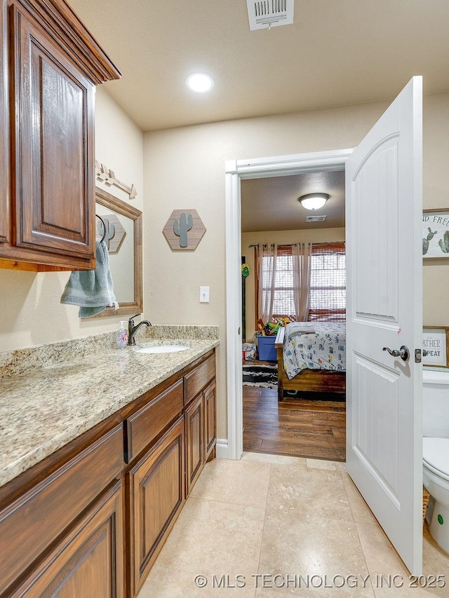 bathroom featuring tile patterned floors, vanity, and toilet