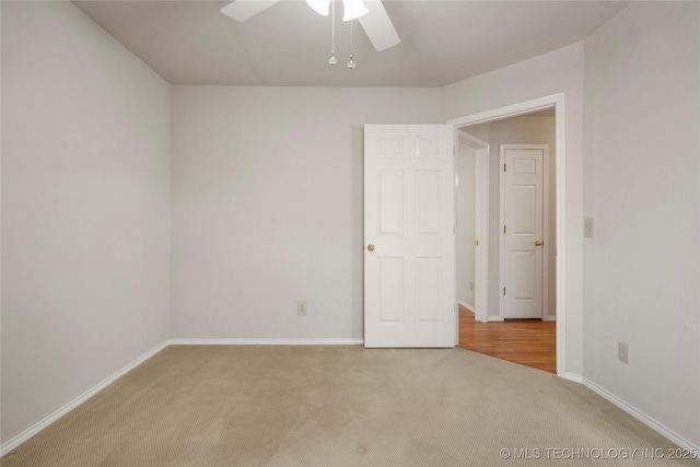 empty room with light carpet and ceiling fan