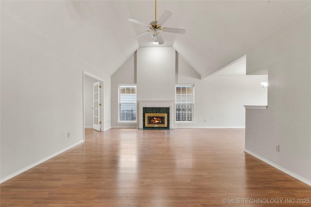 unfurnished living room featuring hardwood / wood-style flooring, a fireplace, high vaulted ceiling, and ceiling fan