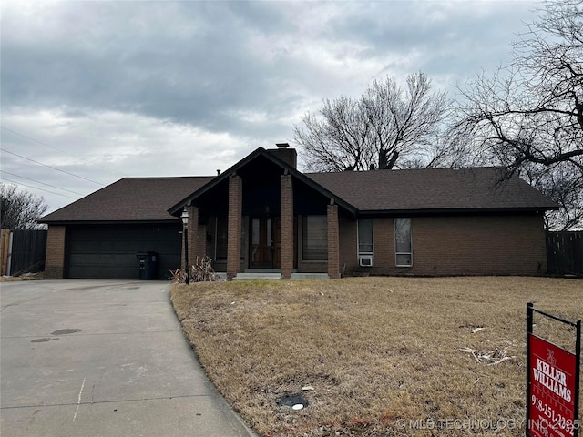 ranch-style house with a garage and a front yard