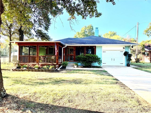 ranch-style home featuring a garage, a front yard, and a porch