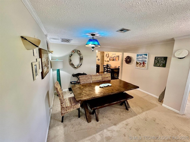 carpeted dining area with crown molding and a textured ceiling