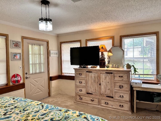 bedroom with ornamental molding, light carpet, and a textured ceiling