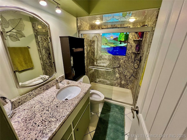 bathroom featuring tile patterned flooring, vanity, a shower with door, and toilet