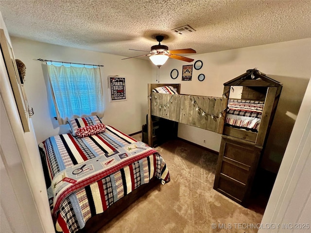 bedroom with carpet flooring, a textured ceiling, and ceiling fan