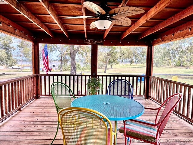 wooden terrace featuring ceiling fan