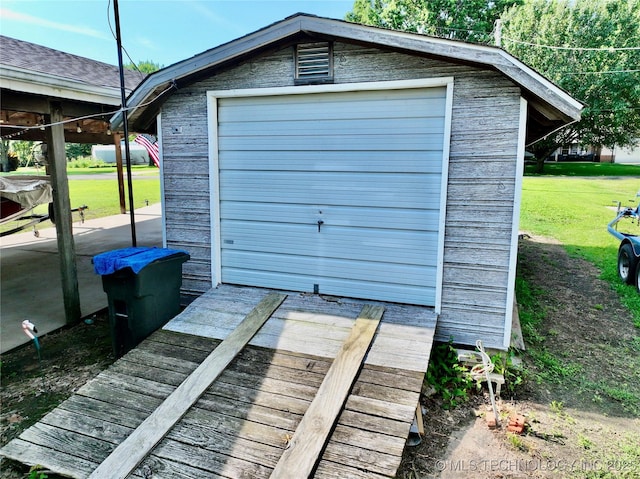 garage featuring a lawn