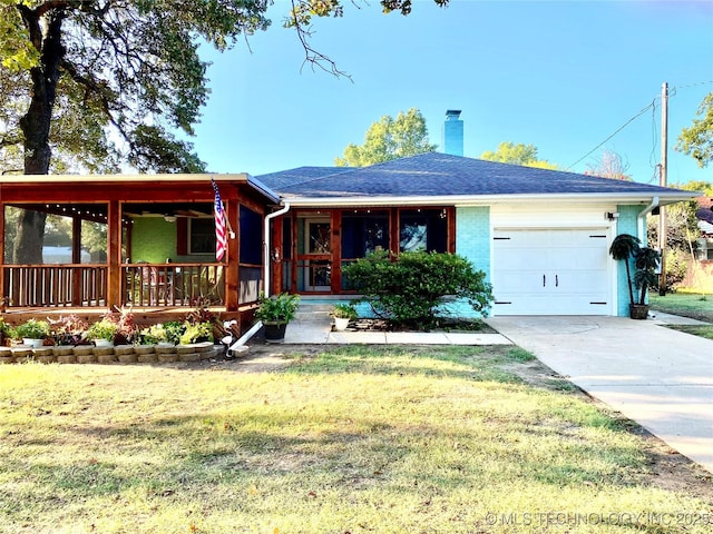 single story home with a porch, a garage, and a front lawn