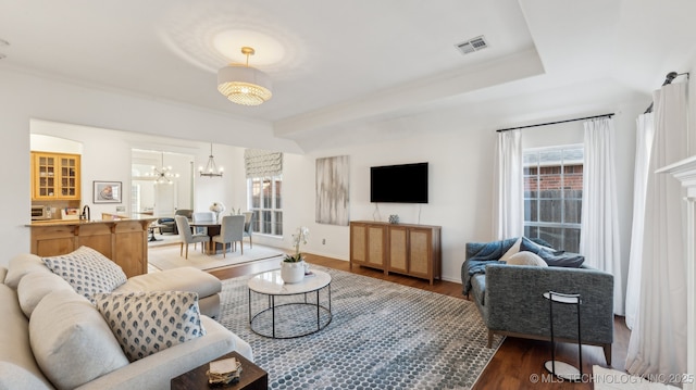 living room featuring sink, hardwood / wood-style floors, and a chandelier