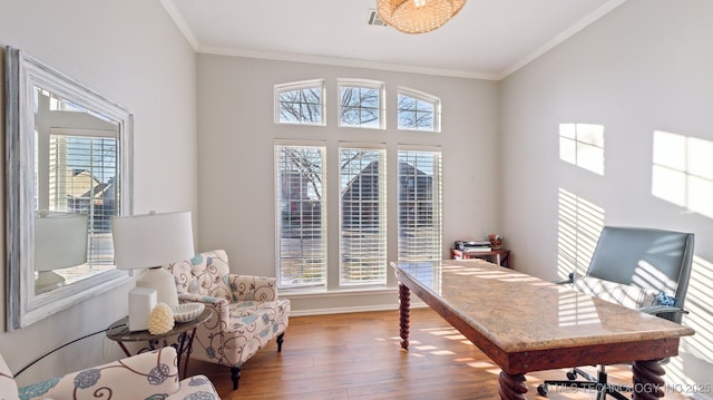 office area with hardwood / wood-style floors and ornamental molding