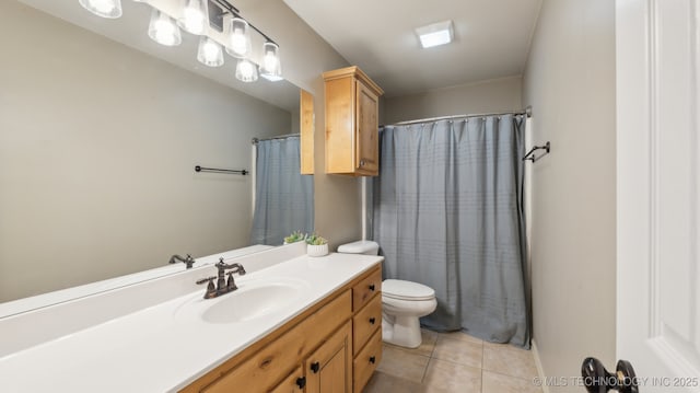 bathroom with vanity, tile patterned floors, and toilet