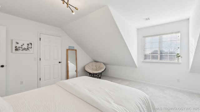 bedroom featuring vaulted ceiling and light colored carpet