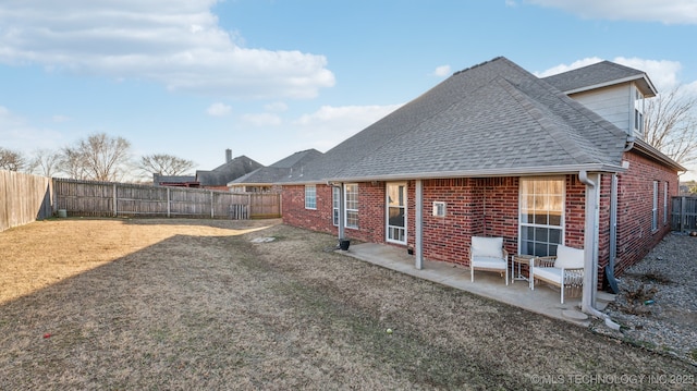 back of house with a yard and a patio area