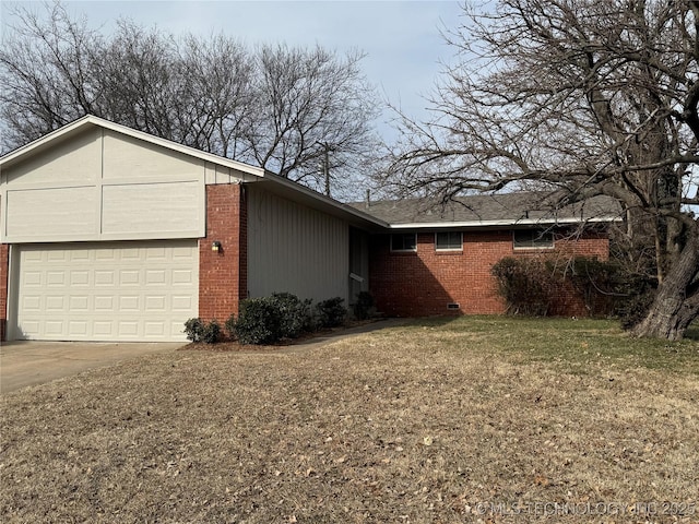 view of side of home with a garage and a lawn