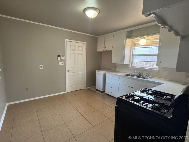 kitchen with light tile patterned flooring, black gas range oven, white cabinetry, sink, and crown molding