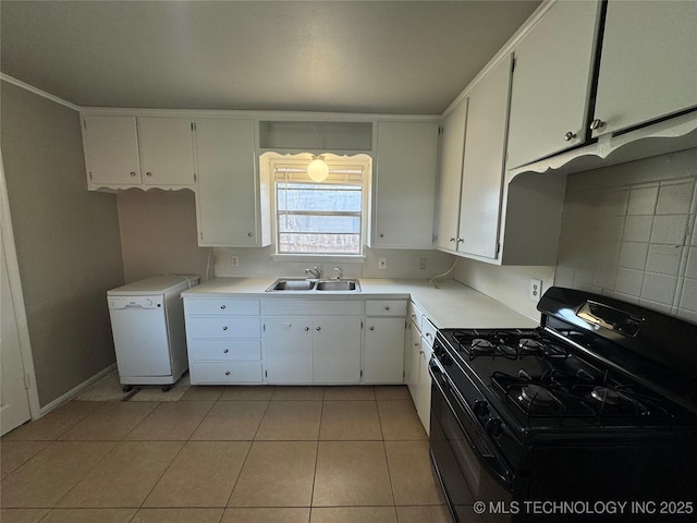 kitchen with sink, light tile patterned floors, black gas range, white cabinets, and decorative backsplash