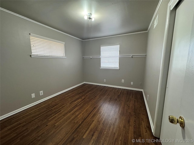 unfurnished room with crown molding and dark hardwood / wood-style floors