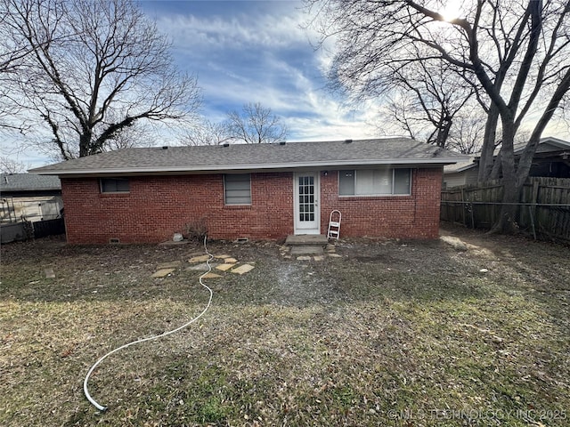 rear view of property featuring a yard