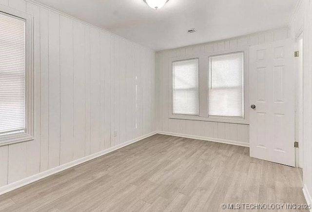 spare room with light wood-type flooring