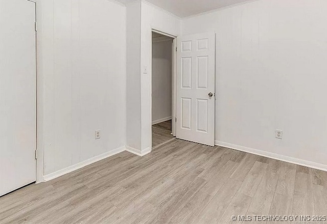 empty room with light hardwood / wood-style flooring