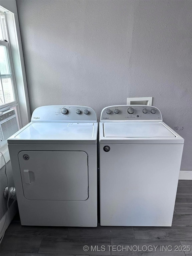 clothes washing area featuring dark hardwood / wood-style flooring and independent washer and dryer