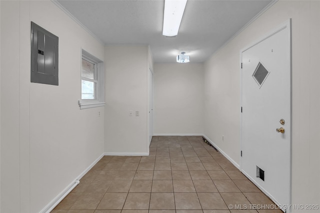 unfurnished room featuring light tile patterned flooring, electric panel, and crown molding