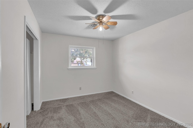 unfurnished bedroom with ceiling fan, carpet flooring, and a textured ceiling