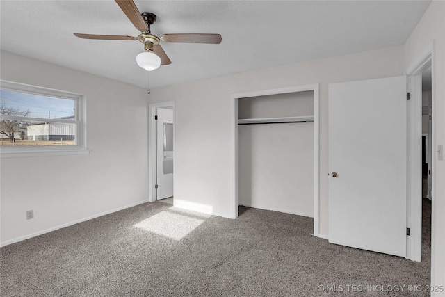 unfurnished bedroom featuring ceiling fan, dark carpet, and a closet